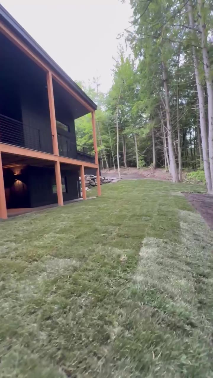A walkthrough of the finished 9,000 sq ft tall fescue lawn beside the modern home in Quechee, VT