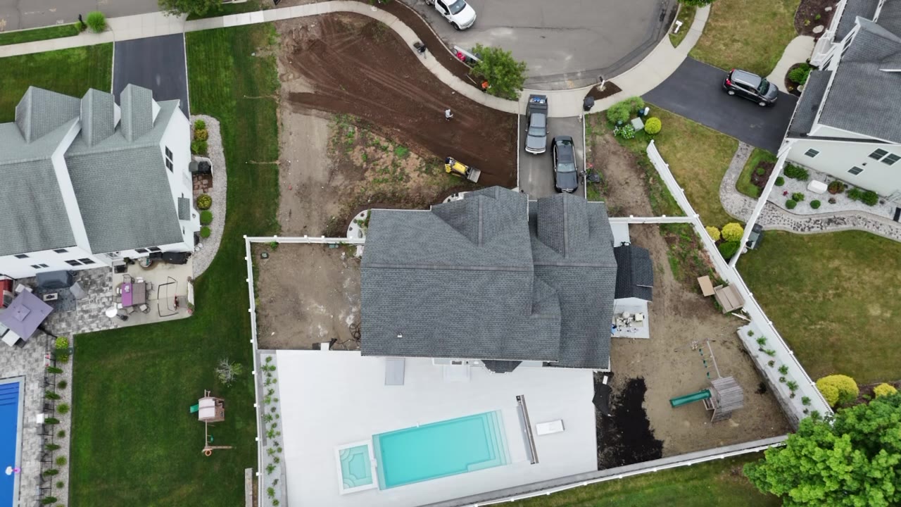 Drone overview of a Milford, CT property the day before a 7,000 sq ft tall fescue sod install — graded front and back yards ready for fresh sod