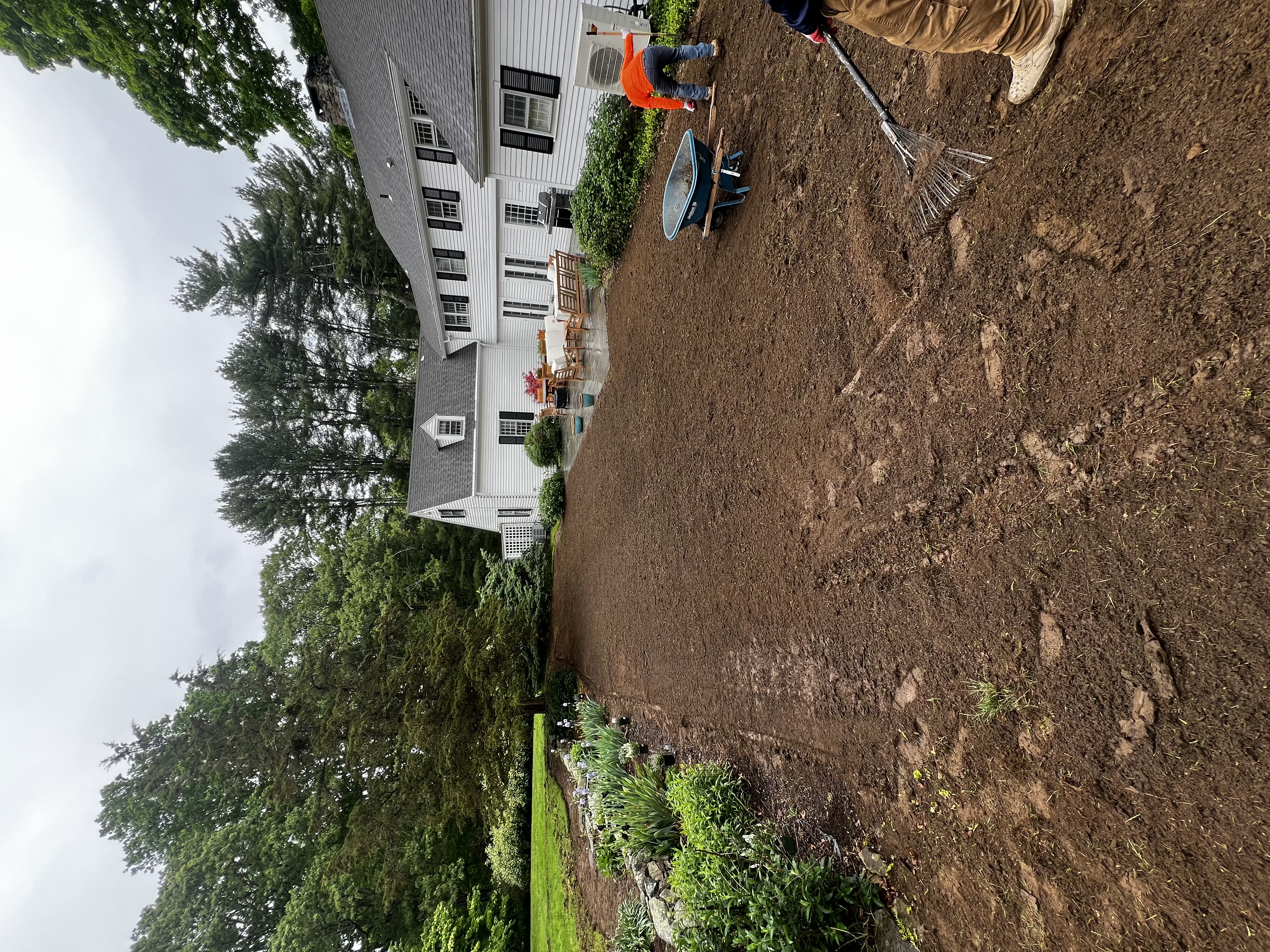 Crew hand-raking the patio edge during 6,000 sqft sod prep in Westbrook CT