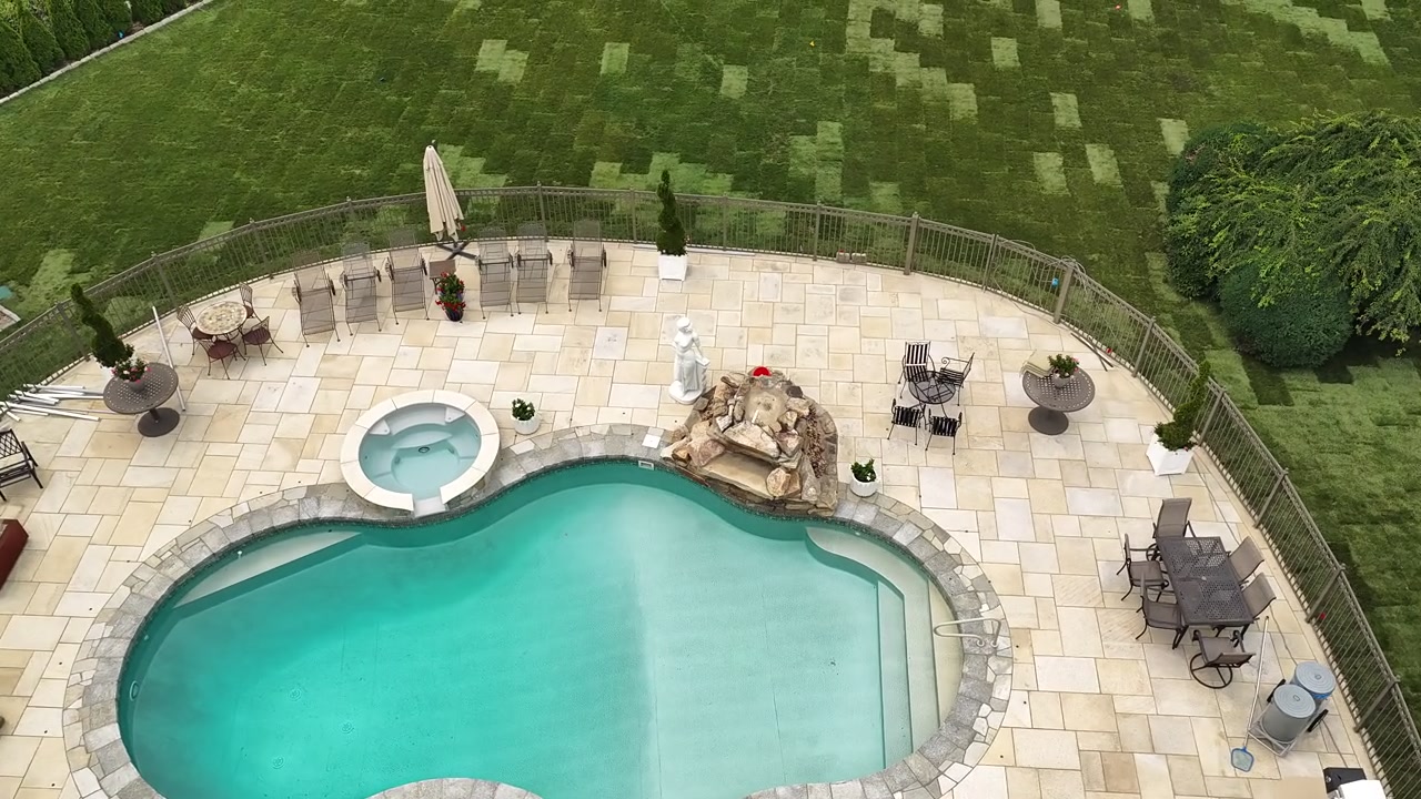 Drone view rising from the Shelton, CT pool deck to a wide view of the whole property covered in fresh sod