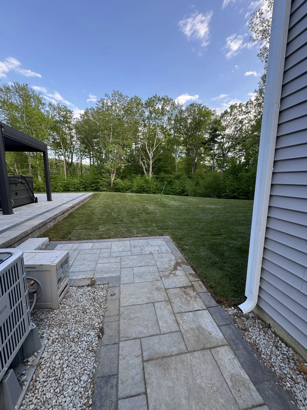 Established Kentucky Bluegrass sod lawn behind home in evening light — Millbury MA Worcester County install completed by CT Sod